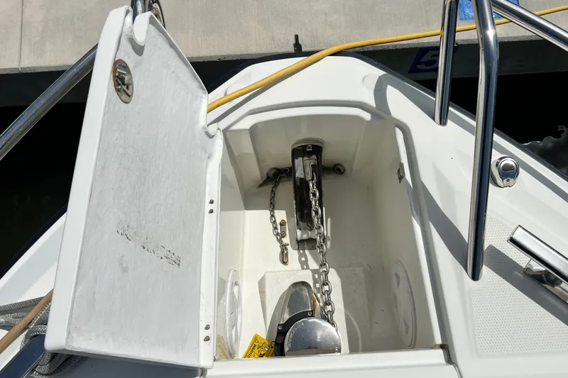 Slide: The Image of Anchor compartment of 2024 Skamander 100 Sorrento boat with chain and winch. - 93