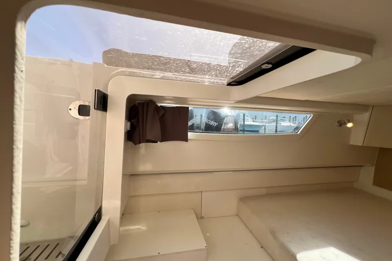 Slide: The Image of Interior cabin of 2024 Skamander 100 Sorrento boat with window and seating area. - 184