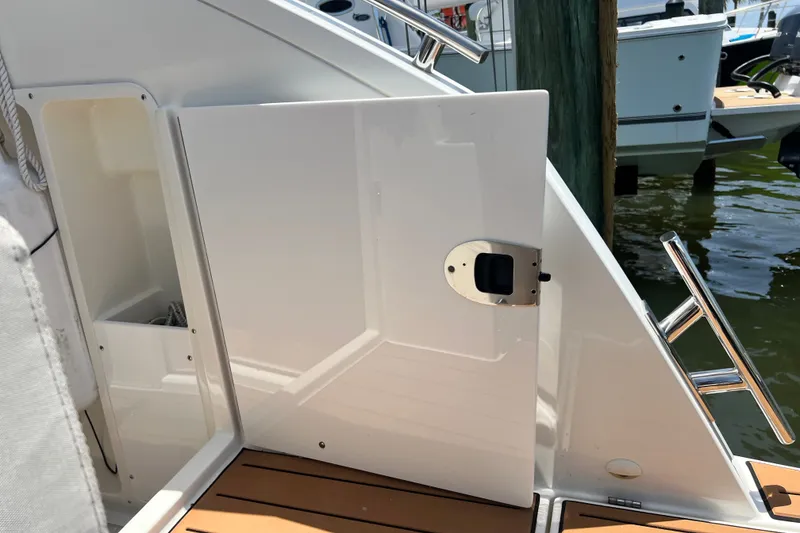 Slide: The Image of 2024 Skamander 100 Sorrento yacht deck with open door and polished railing. - 80
