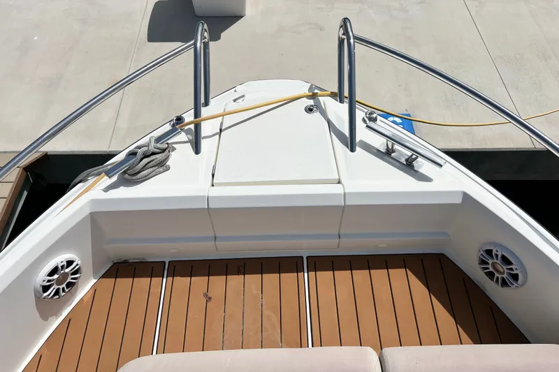 Slide: The Image of 2024 Skamander 100 Sorrento boat deck with wood finish and stainless steel railings. - 92