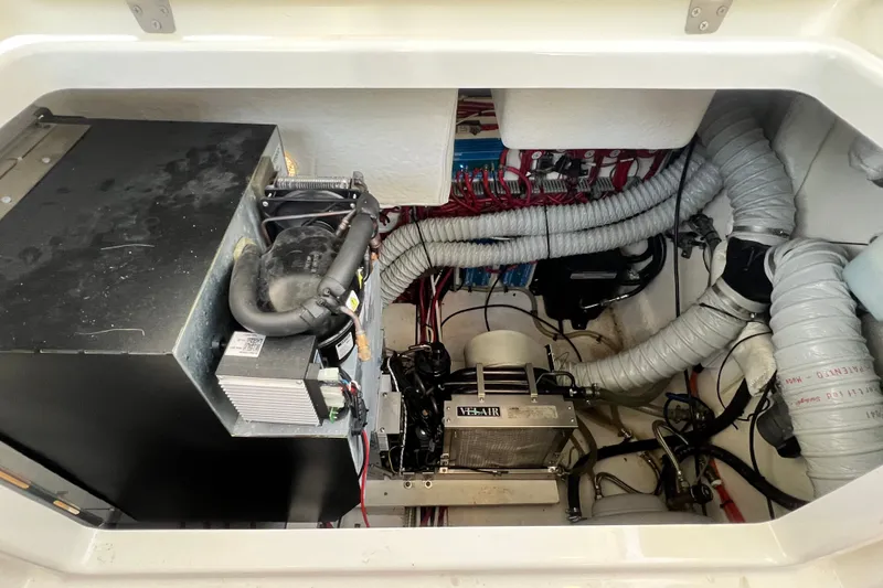 Slide: The Image of Engine compartment of 2024 Skamander 100 Sorrento with visible wiring and ventilation ducts. - 156