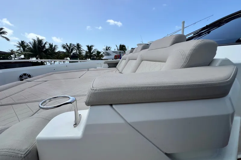 Slide: The Image of Luxurious seating on 2024 Skamander 100 Sorrento yacht with palm trees in background. - 107