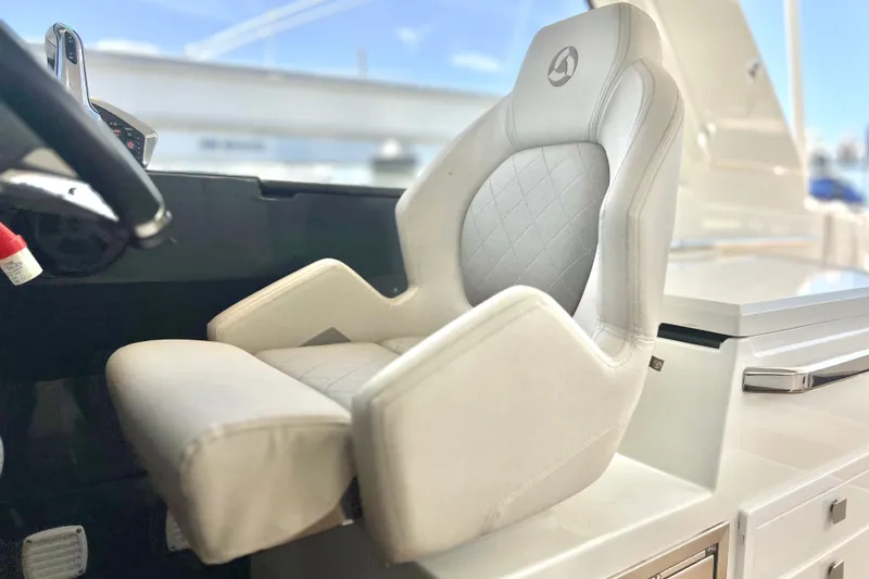 Slide: The Image of 2024 Skamander 100 Sorrento boat interior with luxurious white captain's seat. - 122