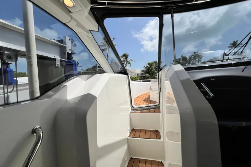Slide: The Image of 2024 Skamander 100 Sorrento boat interior with sleek design and wooden steps. - 86
