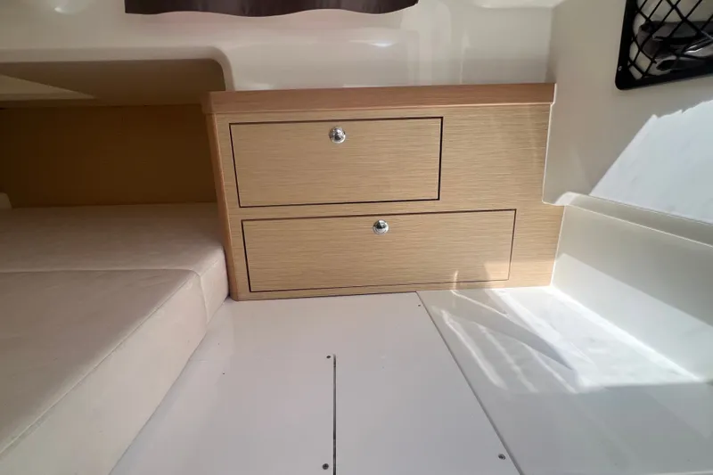 Slide: The Image of 2024 Skamander 100 Sorrento interior with wooden drawers and cushioned seating. - 189