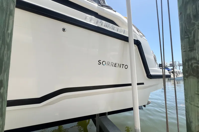 Slide: The Image of 2024 Skamander 100 Sorrento boat docked, showcasing sleek design and branding. - 55
