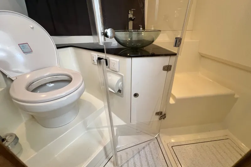 Slide: The Image of 2024 Skamander 100 Sorrento bathroom with toilet, glass sink, and shower area. - 139