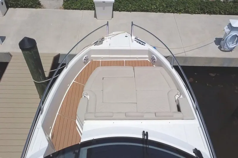 Slide: The Image of 2024 Skamander 100 Sorrento boat with spacious deck and seating, docked at marina. - 14