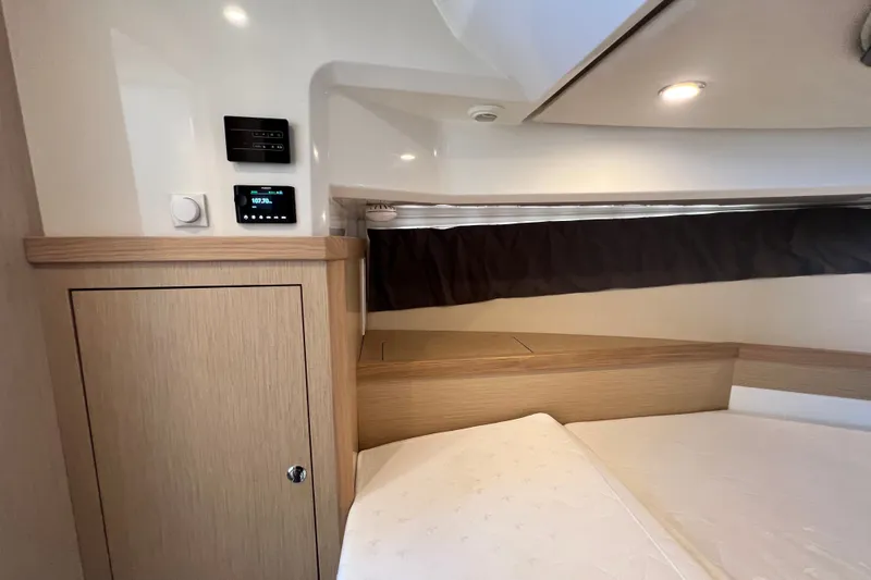 Slide: The Image of 2024 Skamander 100 Sorrento cabin interior with wood cabinetry and modern controls. - 144