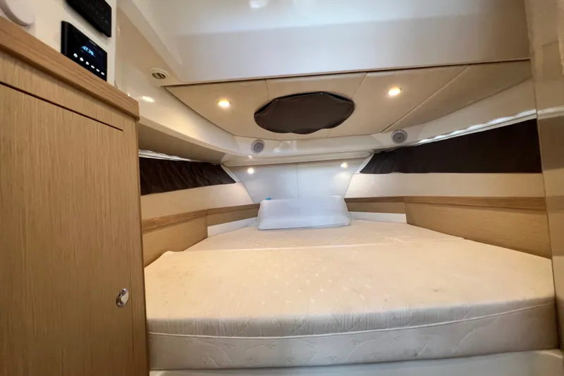 Slide: The Image of 2024 Skamander 100 Sorrento cabin interior with cozy bed and modern lighting. - 142