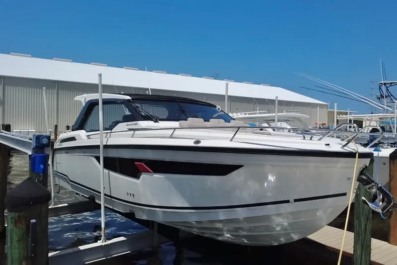 Slide: The Image of 2024 Skamander 100 Sorrento boat docked at marina under clear blue sky. - 9
