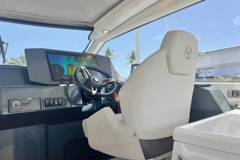 Slide: The Image of 2024 Skamander 100 Sorrento boat cockpit with modern steering and control panel. - 124