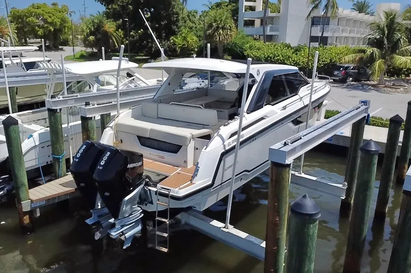 Slide: The Image of 2024 Skamander 100 Sorrento boat docked with dual Mercury engines. - 7