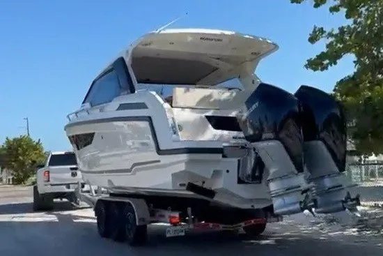 Slide: The Image of Parker Poland Sorrento 100, 2024, on a trailer with two outboard engines. - 10