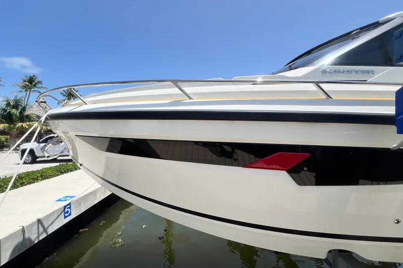 Slide: The Image of 2024 Skamander 100 Sorrento boat docked, sleek design with clear blue sky background. - 50