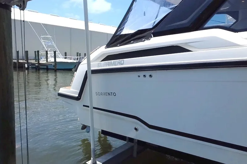 Slide: The Image of 2024 Skamander 100 Sorrento boat docked at marina, side view. - 25