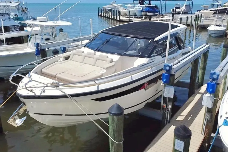 The Image of 2024 Skamander 100 Sorrento luxury boat docked at marina, featuring sleek design and spacious seating. - 0