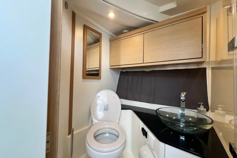 Slide: The Image of Modern bathroom in 2024 Skamander 100 Sorrento yacht with glass sink and wooden cabinets. - 136