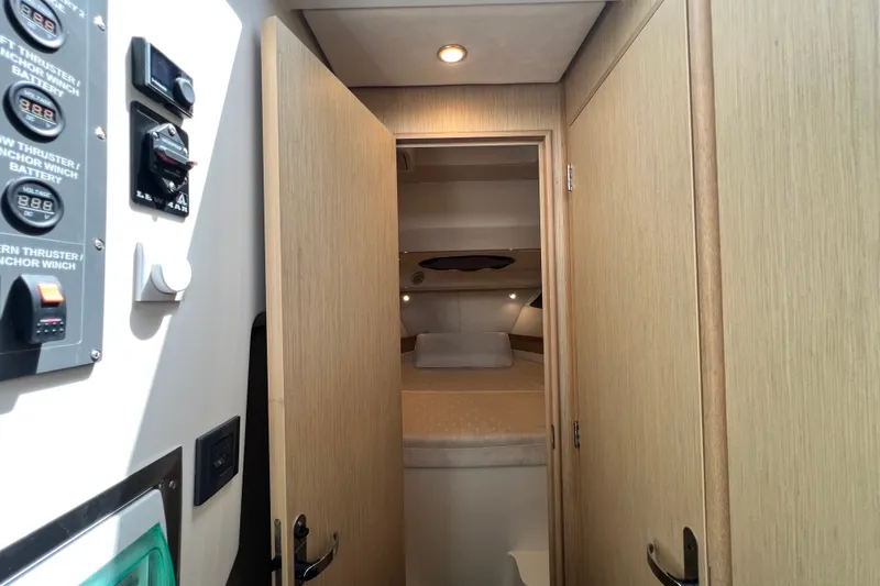 Slide: The Image of 2024 Skamander 100 Sorrento cabin interior with control panel and cozy sleeping area. - 141
