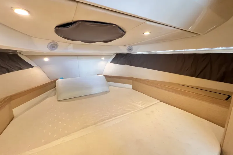 Slide: The Image of 2024 Skamander 100 Sorrento cabin interior with cozy bed and modern lighting. - 143