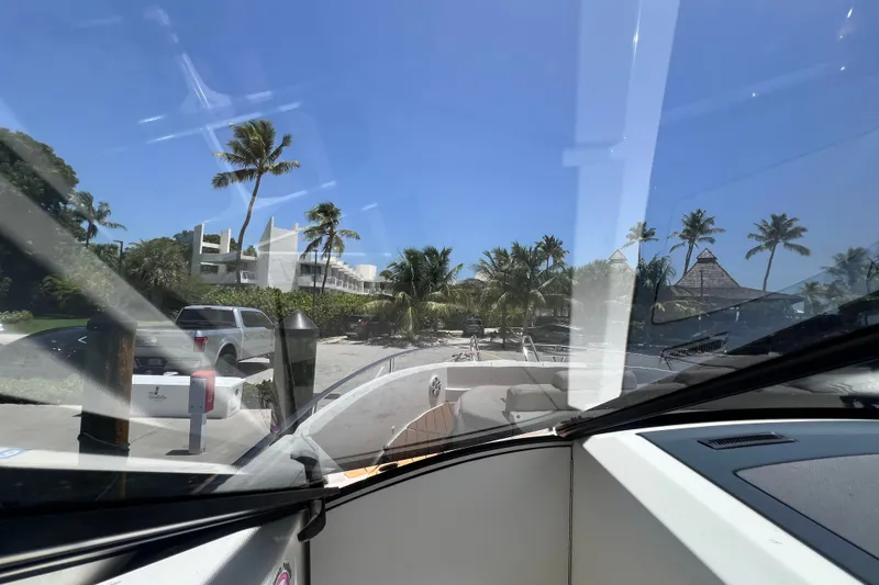 Slide: The Image of 2024 Skamander 100 Sorrento boat docked near tropical resort with palm trees. - 167