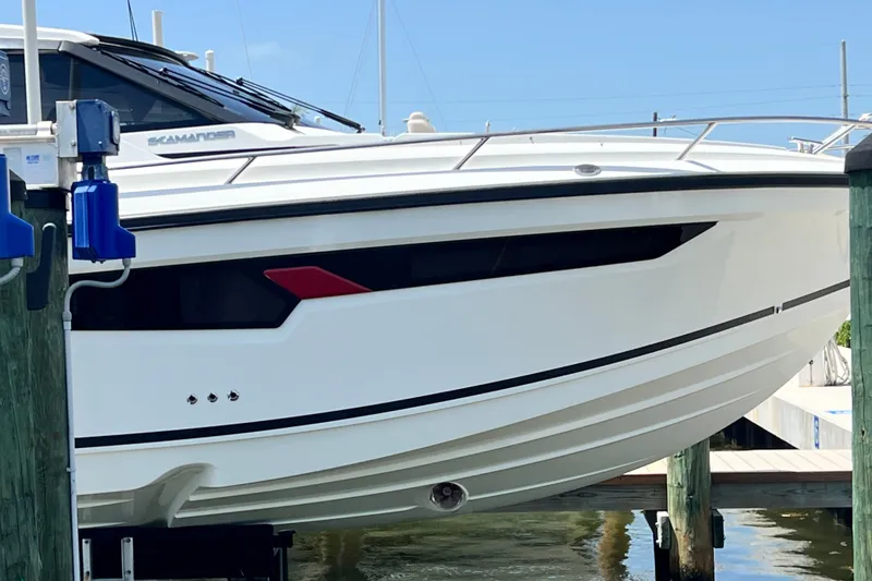Slide: The Image of 2024 Skamander 100 Sorrento boat docked, showcasing sleek white hull design. - 27