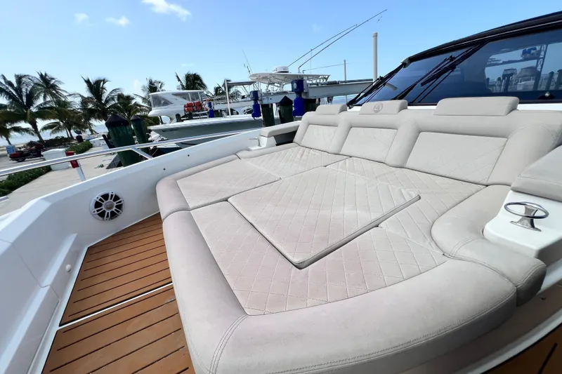 Slide: The Image of Luxurious seating on 2024 Skamander 100 Sorrento yacht, docked with palm trees in background. - 108