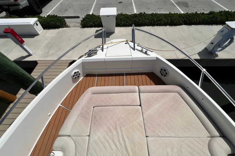 Slide: The Image of 2024 Skamander 100 Sorrento boat deck with cushioned seating and wood flooring. - 91