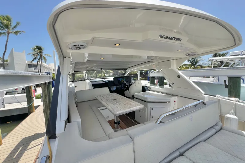 Slide: The Image of 2024 Skamander 100 Sorrento luxury yacht interior with seating and table, docked at marina. - 57