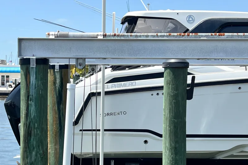 Slide: The Image of 2024 Skamander 100 Sorrento boat docked at marina, side view. - 26