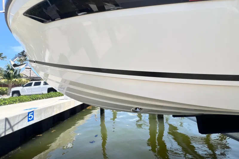 Slide: The Image of 2024 Skamander 100 Sorrento yacht docked, reflecting on calm water. - 51