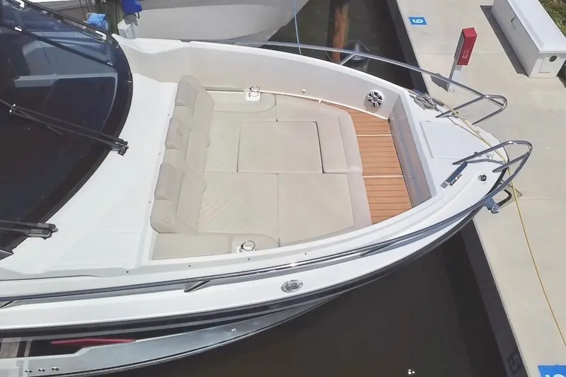 Slide: The Image of 2024 Skamander 100 Sorrento boat with spacious seating and sleek design at dock. - 32