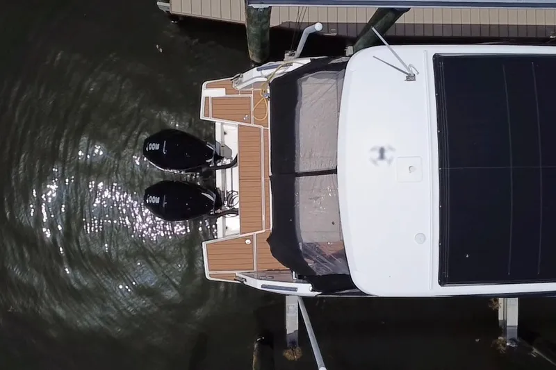Slide: The Image of Aerial view of 2024 Skamander 100 Sorrento boat docked with dual outboard motors. - 16