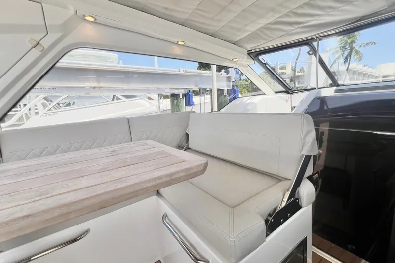 Slide: The Image of Interior of 2024 Skamander 100 Sorrento yacht with elegant seating and wooden table. - 115