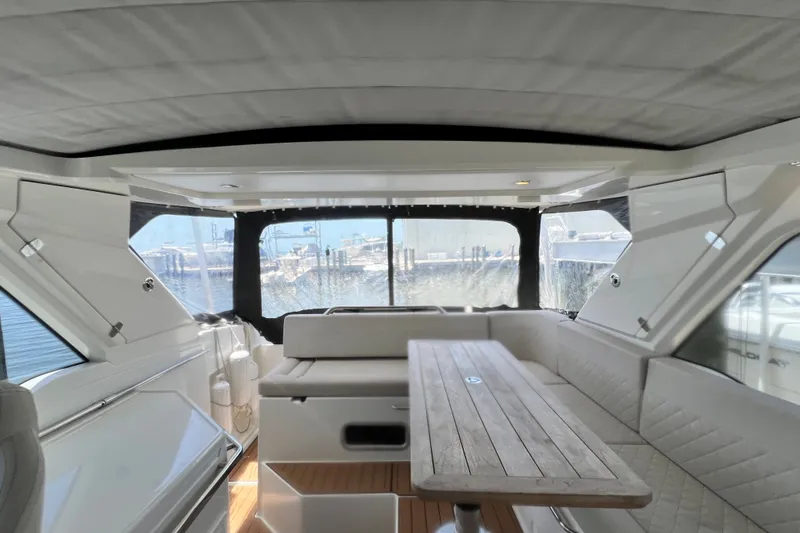 Slide: The Image of Interior of 2024 Skamander 100 Sorrento yacht with seating and wooden table. - 176