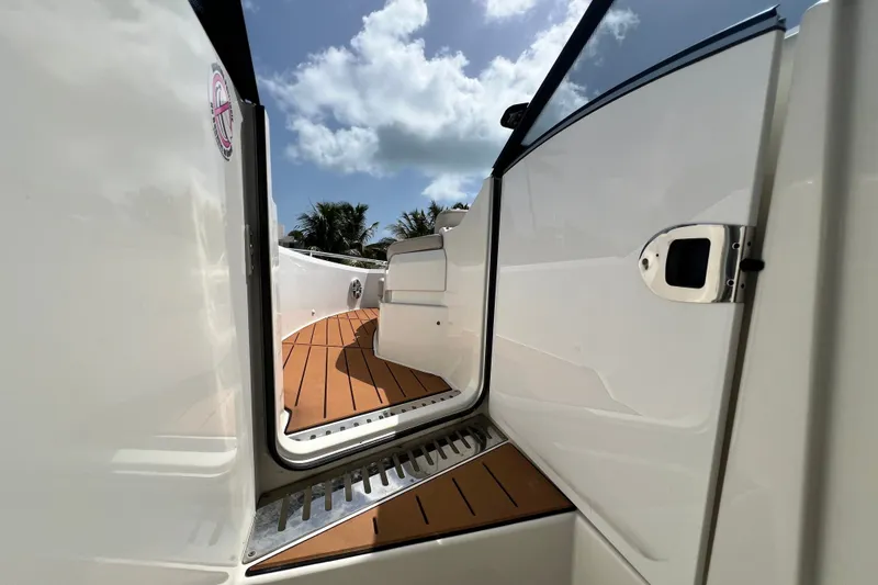 Slide: The Image of 2024 Skamander 100 Sorrento boat deck with open door, showcasing sleek design and wood finish. - 87