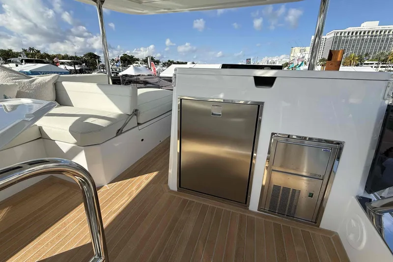 Slide: The Image of Aventura 38 Motor Yacht 2026 deck with seating and stainless steel appliances. - 7