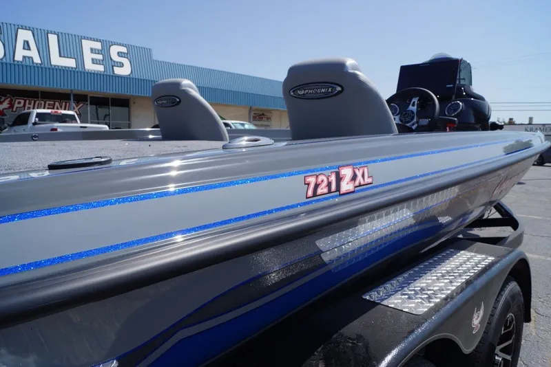 Slide: The Image of 2027 Phoenix 721 ZXL boat displayed outside a sales building. - 3