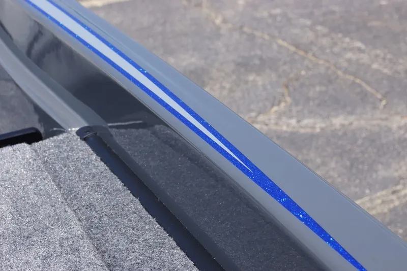 Slide: The Image of Close-up of 2027 Phoenix 721 ZXL boat with blue stripe detail. - 16