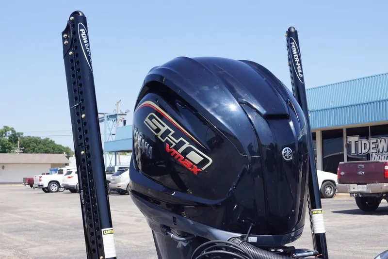 Slide: The Image of Outboard motor on a 2027 Phoenix 721 ZXL boat in a parking lot. - 2