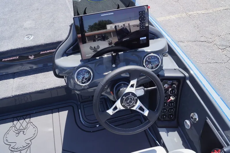 Slide: The Image of Steering console of 2027 Phoenix 721 ZXL boat with digital display and controls. - 12