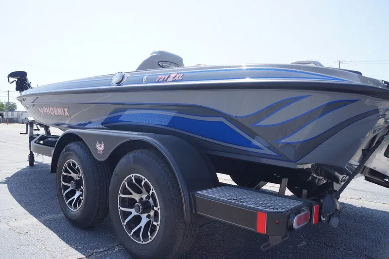 Slide: The Image of 2027 Phoenix 721 ZXL boat on trailer, featuring sleek blue and gray design. - 10