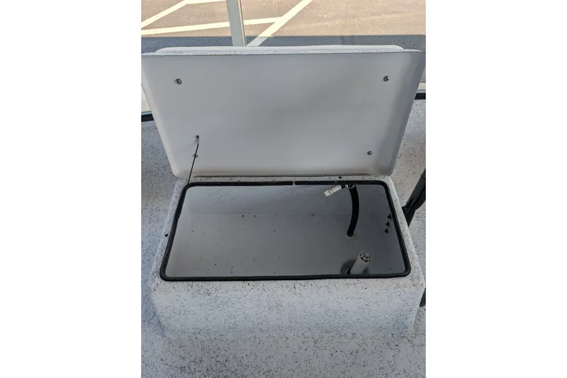 Slide: The Image of Open storage compartment on 2026 Gheenoe Lo Tide 25 boat, showing interior details. - 7