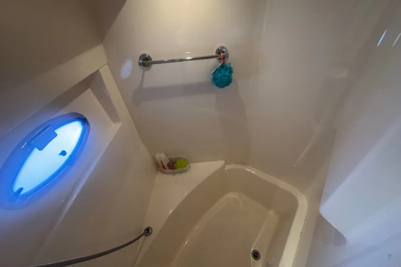 Slide: The Image of Bathroom interior of 2003 Carver 570 Voyager Pilothouse with porthole and shower amenities. - 24