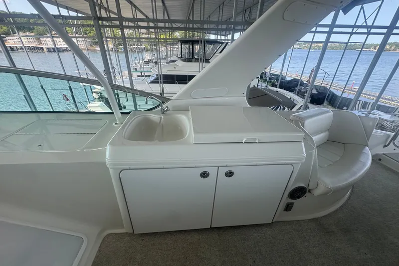 Slide: The Image of 2003 Carver 570 Voyager Pilothouse yacht interior with sink and seating area. - 16