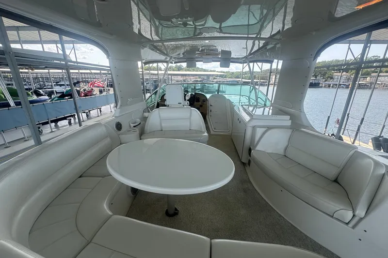 Slide: The Image of Luxurious interior of 2003 Carver 570 Voyager Pilothouse yacht with white seating and table. - 14