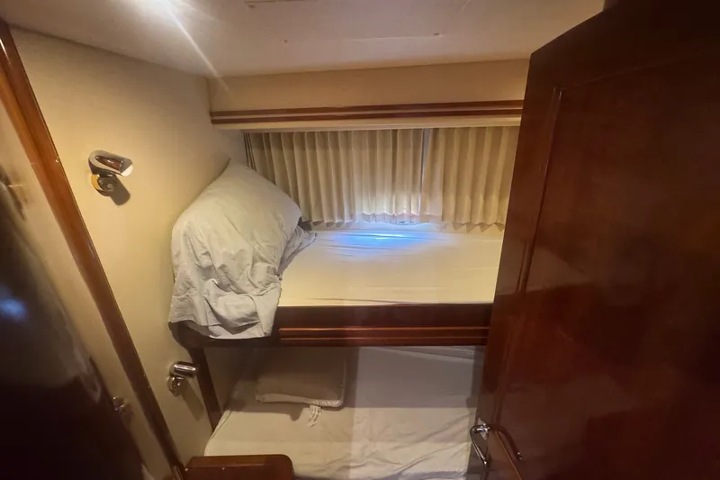 Slide: The Image of Cozy cabin interior of 2003 Carver 570 Voyager Pilothouse with bunk beds and wooden accents. - 25