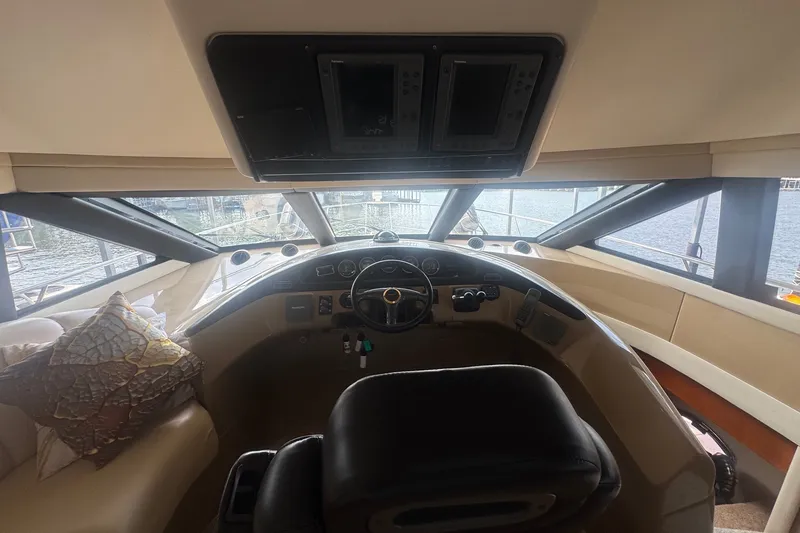 Slide: The Image of Interior view of 2003 Carver 570 Voyager Pilothouse helm with panoramic windows. - 20