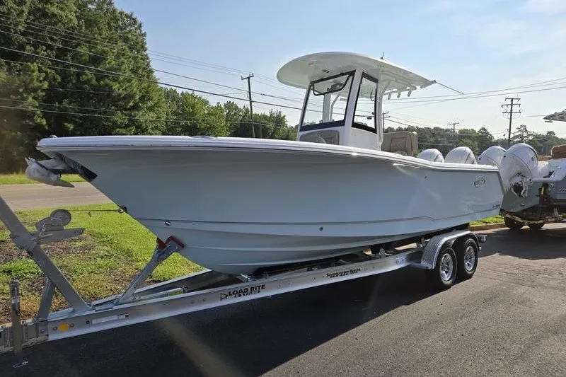 The Image of 2026 Sea Hunt Gamefish 25 boat on trailer, parked outdoors, side view. - 1