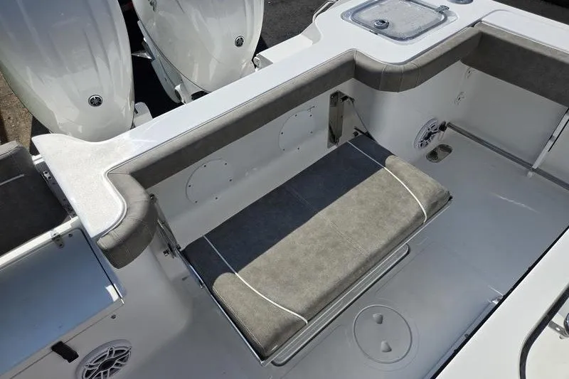 Slide: The Image of 2026 Sea Hunt Gamefish 25 boat interior with cushioned seating and dual engines. - 24